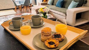 A breakfast tray with coffee, orange juice, and pastries on a tray. - Fully equipped, by the sea in a quiet residential area near Olhão. (Moncarapacho)