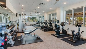 A gym with treadmills, elliptical machines, and weightlifting equipment. - Blu 205 ~ Oceanfront 4BR/3BA ~ True Luxury + 2 SETS Free Beach Svc (Fort Walton Beach)