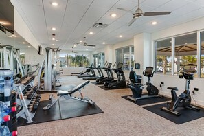 A gym with treadmills, elliptical machines, and weightlifting equipment.