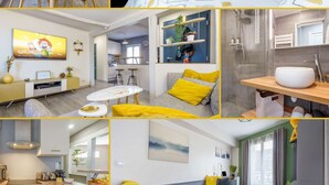 Une chambre d’hôtel moderne comprenant un lit, un coin repas, une cuisine et une salle de bain.
