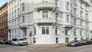 A white, multi-story building with classical architecture, including ornate balconies and decorative moldings. - Limehome Vienna Roßauer Lände (Vienna)