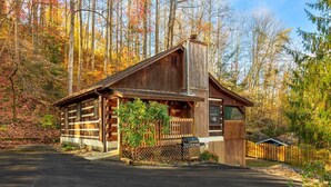 A rustic cabin with a chimney, a porch, and a garage. - 1mi From Parkway ~ Hot Tub ~ Fire Place (Gatlinburg)
