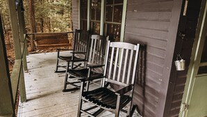 A porch with three wooden rocking chairs and a bench. - Cozy Waterfront Lake Cabin - New Listing - Adirondacks - Long Lost Lodge (Malone)