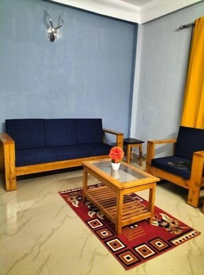 Relax in this inviting living room with a sofa, coffee table, and armchairs.