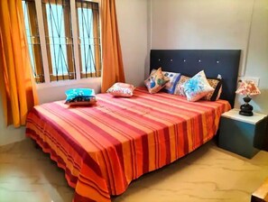 Restful retreat with a large bed, pillows, and a bedside table.