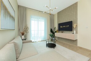 Deluxe Apartment | Living area | 55-inch Smart TV with cable channels - Grand Luxury - Charming Condo With Balcony In The Heart of JLT (Dubai)