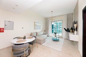 Deluxe Apartment | Living area | 55-inch Smart TV with cable channels - Grand Luxury - Charming Condo With Balcony In The Heart of JLT (Dubai)