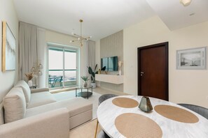 Deluxe Apartment | Living area | 55-inch Smart TV with cable channels - Grand Luxury - Charming Condo With Balcony In The Heart of JLT (Dubai)