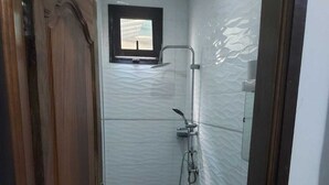 A small bathroom with a toilet, a sink, and a shower. - Private room in very nice area. (Dakar)