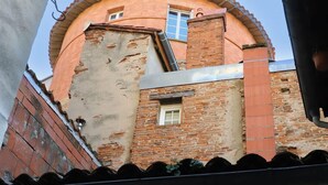 A building with a round, brick structure and a flat roof.