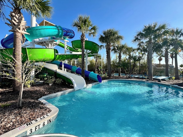 A water park with multiple slides and a pool.