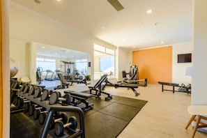 A gym with various exercise equipment, including dumbbells, treadmills, and weight machines. - Casa Estrella at Bayview Village (Lagos)