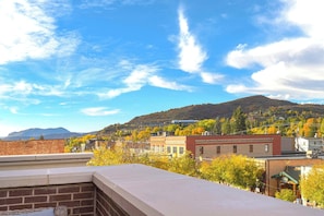 A town with buildings and a mountain in the background.