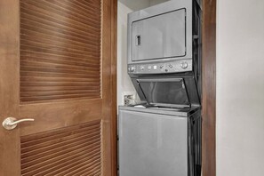 A compact kitchen with a built-in oven and a refrigerator.