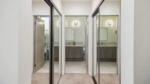 A hallway leading to a kitchen with a glass door, a light fixture, and a tiled floor. - Close to Hollywood and Getty with a Panorama Deck (Los Angeles)