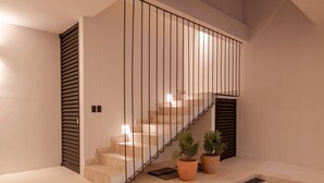Eine moderne Treppe mit Metallgeländer, Blumentöpfen und einem klaren, minimalistischen Design.