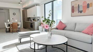 Deluxe Apartment, Multiple Beds, City View | Living area | 50-inch Smart TV with cable channels