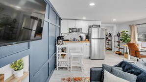 A modern kitchen with white cabinets, stainless steel appliances, and a wooden countertop. - Tampa's Hidden Gem - 1BR/1BA Guest Suite (Tampa)