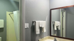 A bathroom with a bathtub, a sink, and a mirror. - Motel 6 Borger, TX – Boom Town (Borger)