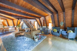 Relax in a spacious loft-style living area with a comfortable sofa set, coffee table, and seating area.