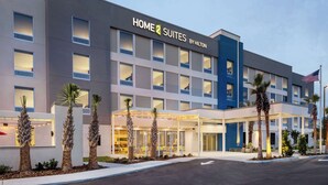 Un hotel moderno con un letrero que dice "HOME 2 SUITES BY HILTON".