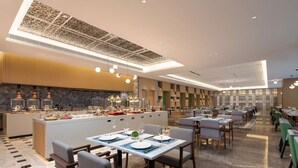 A modern restaurant with a central island, multiple dining tables, and a variety of seating arrangements. - Hilton Garden Inn Shenzhen Guangming Hongqiao Park (Shenzhen)