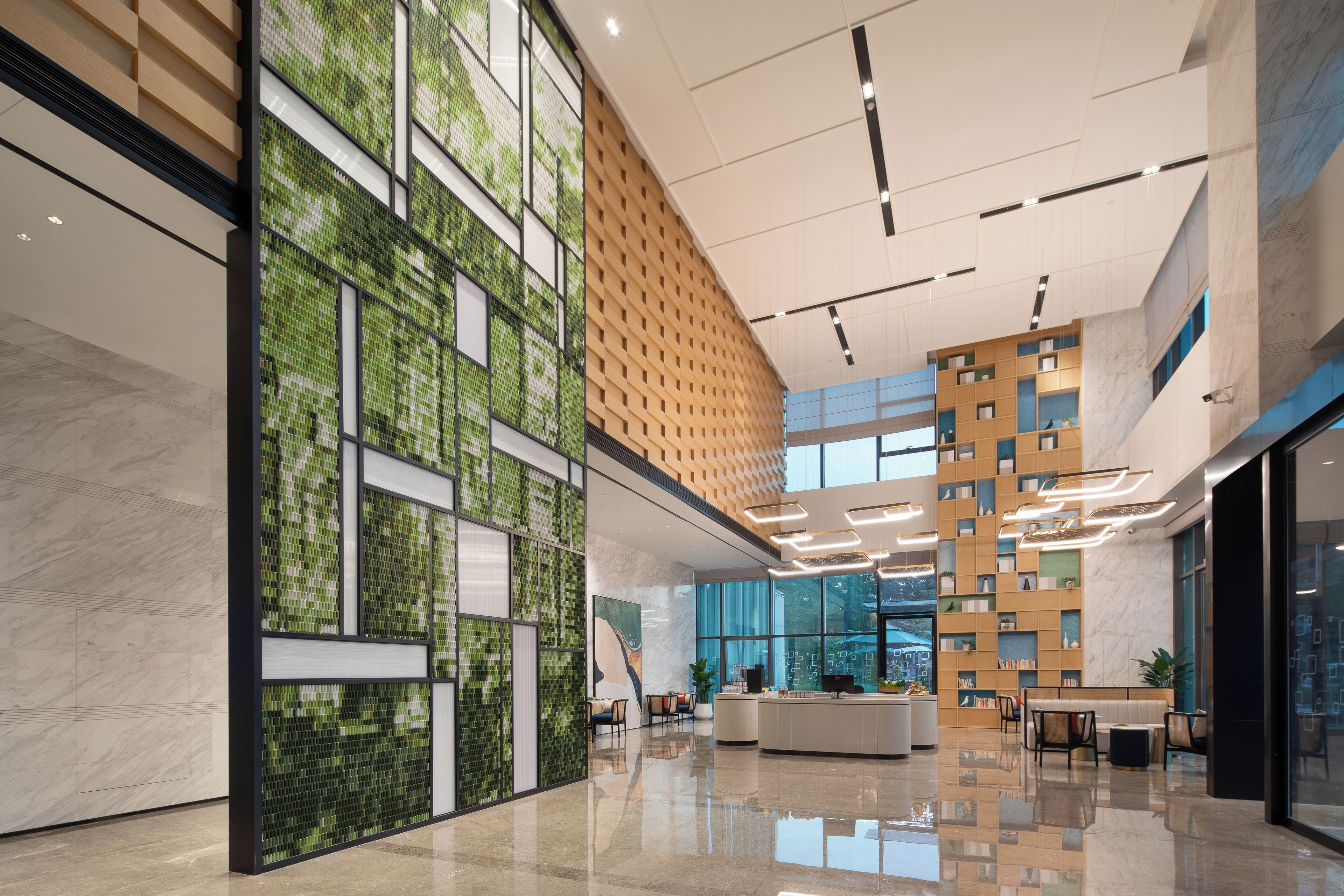 A modern lobby with a high ceiling, a central seating area, and a mix of natural and artificial lighting.
