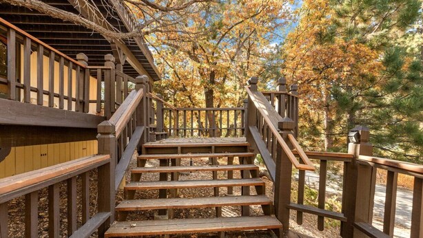 A wooden staircase leading to a building with a wooden railing.