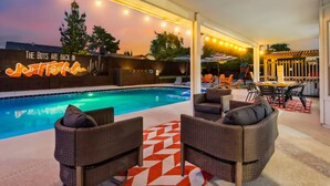An outdoor pool area with wicker furniture and a neon sign. - Scottsdale Paradise! Basketball, Heated Pool, Golf (Scottsdale)
