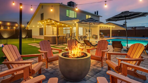 A backyard with a fire pit, outdoor furniture, and string lights. - Scottsdale Paradise! Basketball, Heated Pool, Golf (Scottsdale)
