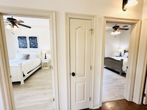 A bedroom with a bed, bedside table, and a ceiling fan. - Villa 7, spacious townhouse in Tickfaw, LA (Tickfaw)