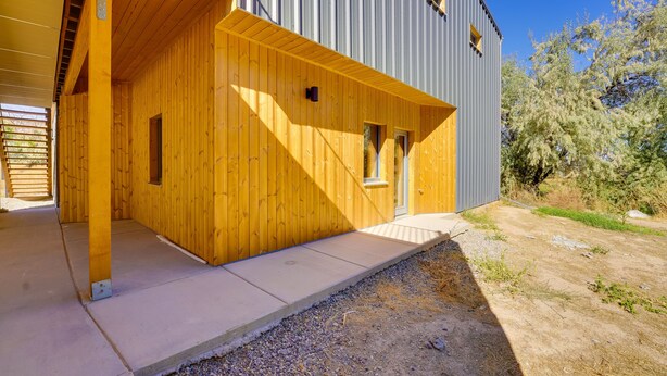 A modern building with a wooden facade and a grey metal exterior. - Unique Grand Junction Guest Suite w/ Gas Fire Pit! (Grand Junction)