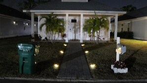 A residential house with a covered porch, a pathway leading to the entrance, and a mailbox on the right. - Delightful 3-bedroom house in Bradenton with WiFi, Games, and more #2 of 2 (Bradenton)