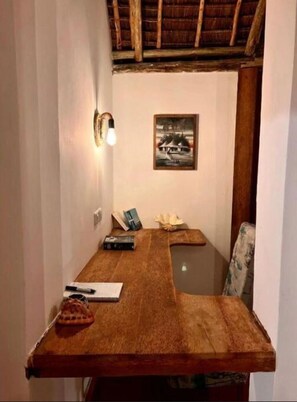 Cozy retreat with a slanted ceiling, simple decor, and a unique touch of artwork.