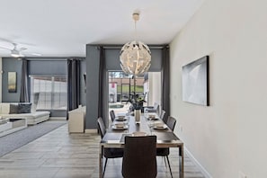A dining area with a table set for six, a ceiling fan, and a view through a glass door. - 1590 Moon Valley Drive (Davenport)