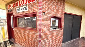 A brick building with a sign reading 'DEL-RIO LODGE OFFICE' and a closed door. - Del Rio Hotel O near Mesa Downtown (Mesa)