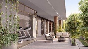A modern outdoor area with a treadmill, seating, and greenery. - Conveniently located 2BR apt w/ rooftop pool @Milt (Milton)