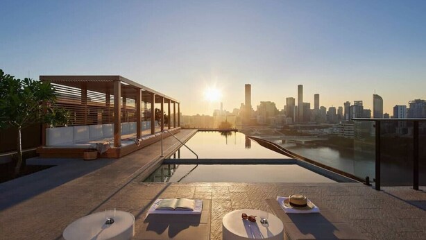 A rooftop terrace with a city skyline view, a pool, and seating areas. - Conveniently located 2BR apt w/ rooftop pool @Milt (Milton)