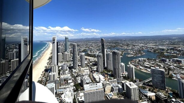 A cityscape with high-rise buildings, a beach, and a river. - Cloudview Retreat | Luxe Skyhome Experience (Surfers Paradise)