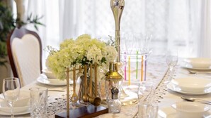 A table set for a formal dining event with a decorative candelabra centerpiece, white tablecloth, and glassware. - Private Cinema! 5Beds Spacious Villa Near Shops (Calamvale)