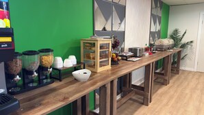 A breakfast bar with a coffee machine, cereal dispensers, a bread display, and a fruit basket. - The Willowbrook Village at Lake Harmony, a Wyndham Hotel (Lake Harmony)