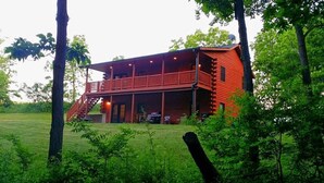 A log cabin with a balcony and a staircase leading to the entrance. - Timber Ridge Lodge -HOT TUB- POOL (Harpers Ferry)