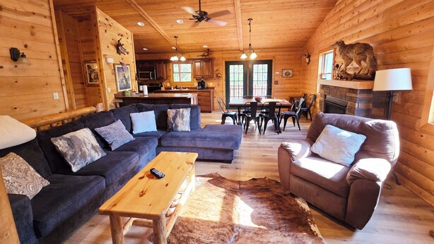 A cozy log cabin interior with a living room, dining area, and kitchen. - Timber Ridge Lodge -HOT TUB- POOL (Harpers Ferry)