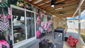 An outdoor patio with a pool table, a sofa, and a covered area with a wooden ceiling. - We are located in the heart of Miami, 10 min away from Downtown, Beaches, M.I.A (Miami)