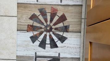 A wooden wall with a decorative sign that reads "FINE" in large letters, accompanied by a geometric design.