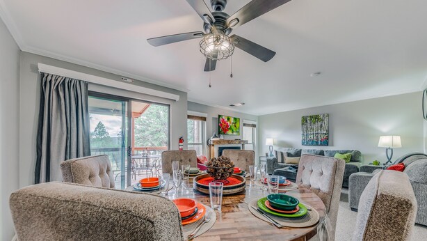 A dining area with a round table set for four, surrounded by upholstered chairs. - On Mountain Time | Upscale Townhome Retreat w/ Cozy Nights & Outdoor Adventure Nearby (Alto)