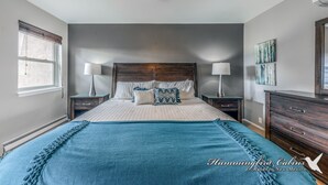 A bedroom with a large bed, two nightstands, a wooden headboard, and a ceiling fan. - On Mountain Time | Upscale Townhome Retreat w/ Cozy Nights & Outdoor Adventure Nearby (Alto)