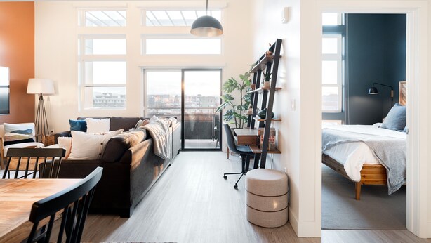 A modern apartment with a dining area, a living room with a sofa and a coffee table, a workspace with a desk and chair, and a bedroom with a bed and a nightstand. - (Denver)