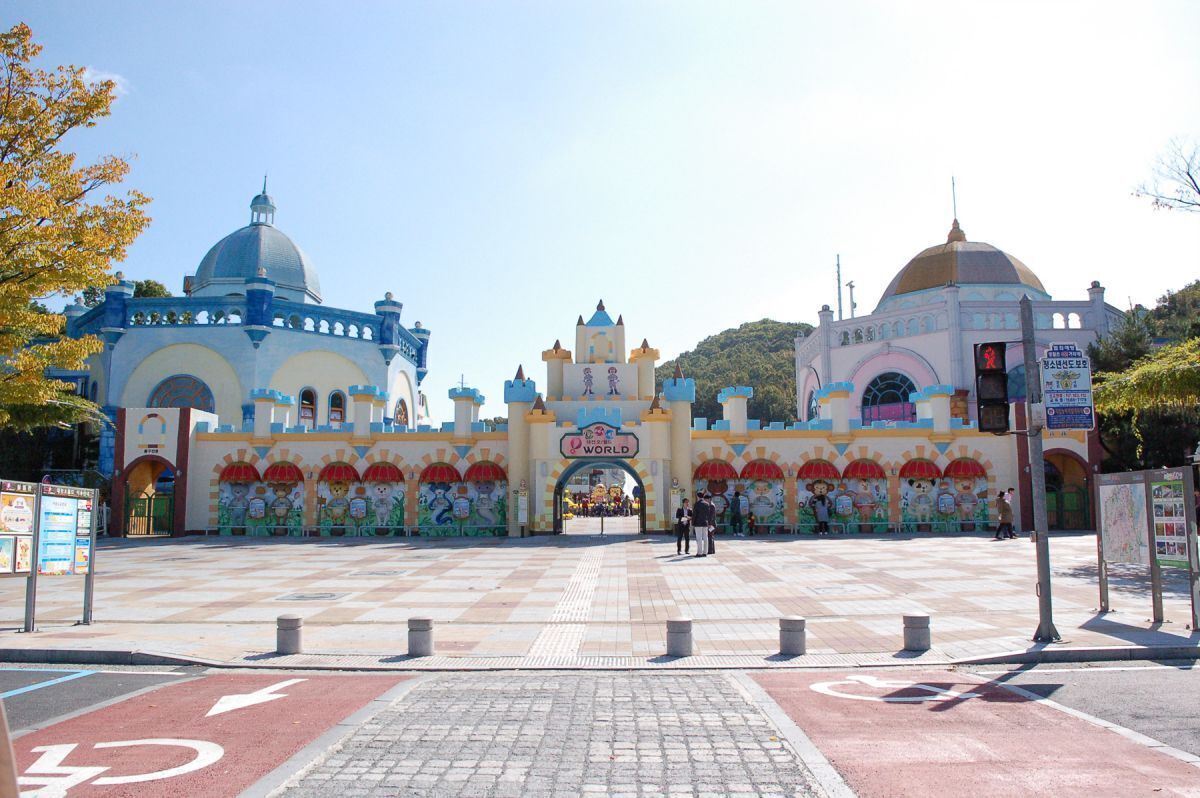 A large, colorful building with a central archway labeled "Disney World."