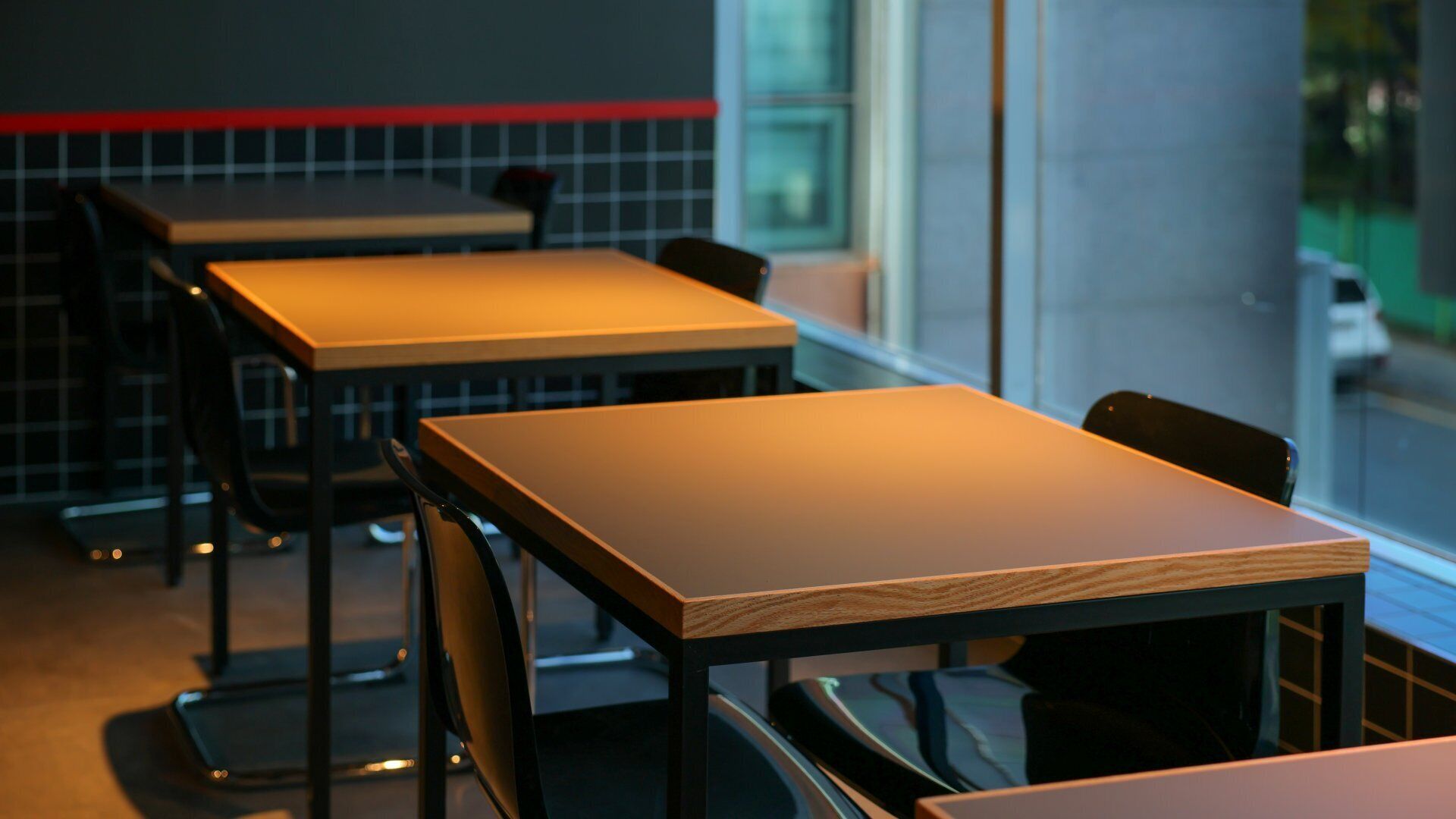 A restaurant interior with tables and chairs.